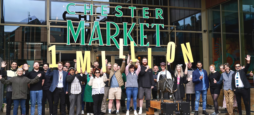 Chester Market traders and staff celebrate the first million visits with Cllr Nathan Pardoe, Cabinet Member for Inclusive Economy, Regeneration and Digital Transformation; left - holding number one.