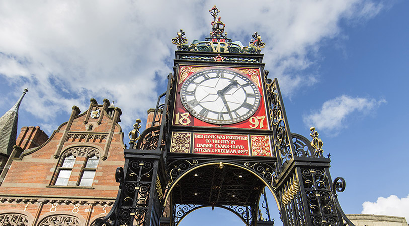 A photograph of Chester's iconic Eastgate Clock against a striking blue sky