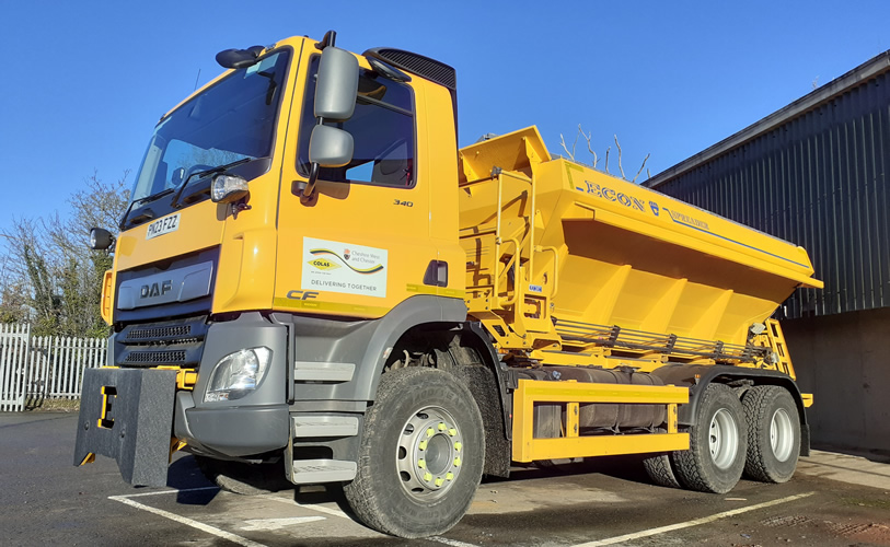 A gritter parked in a depot.