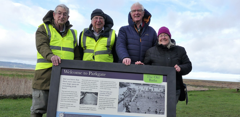 Members of the Parkgate Society with the board that will be situated at the Old Baths. L to R: Derek Haylock, Membership Secretary; Alan Passmore, Secretary; Derick Cotton, Treasurer; Brenda Marple, Committee member.